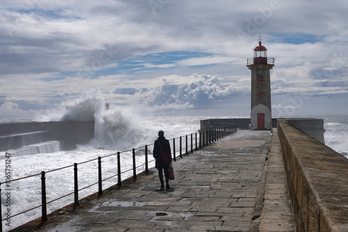 Maritime landscape. Porto landmark, Portugal. Seascape with big wave crashes at the lighthouse.