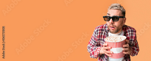 Disgust and shock from film. Surprised guy funny holding bucket of popcorn, close up photo