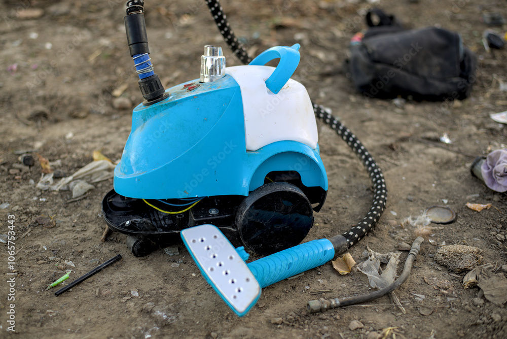 Toy vacuum cleaner in a garbage dump