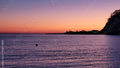 Sea, beach and pebbles, clouds in the sea. photo