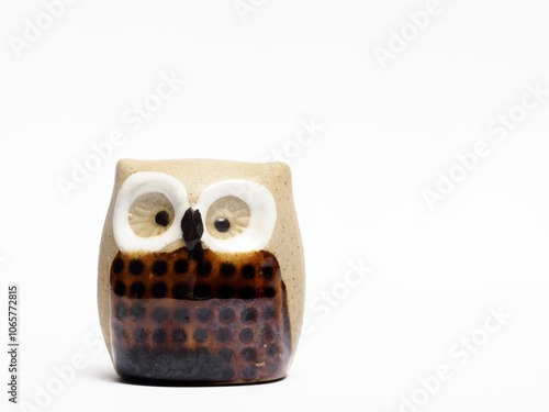 In tis photoillustration Vintage porcelain figurine of owl on white background