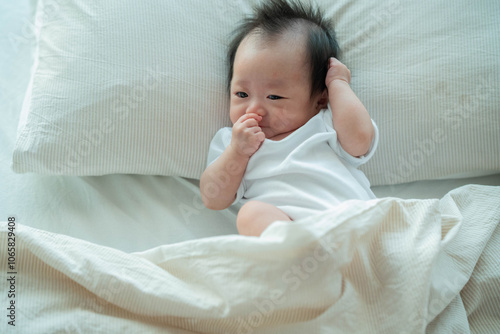 Baby Relaxing on Bed in Soft Morning Light