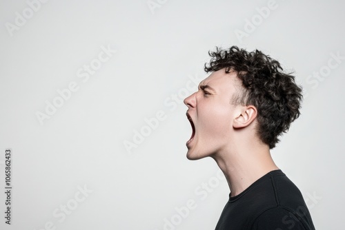 Emotional young man screaming in frustration