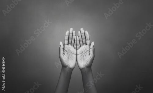 Hands reaching up in a gesture of prayer or supplication photo