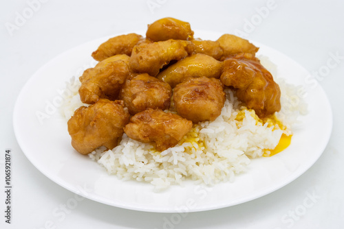 Chinese Lemon Chicken with White Rice on a White Plate