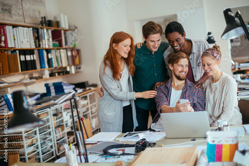 Wallpaper Mural Group of young people using a smart phone together in the office Torontodigital.ca