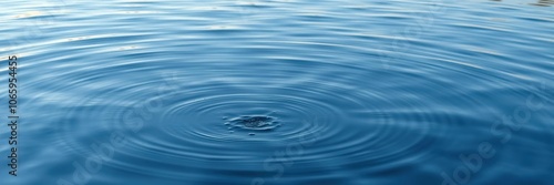 A serene lake with ripples and tiny blue water drops forming on its surface, stillness, water body, lake