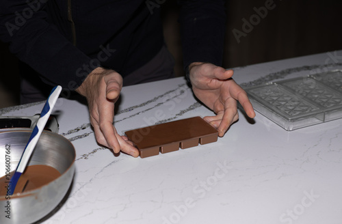 Photography Chef making chocolate , handmade chocolate being poured into a mold , men's hand