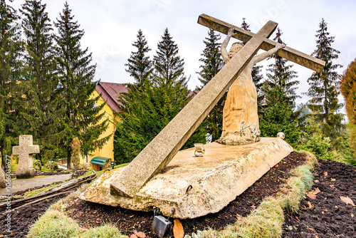 Sculpture Jesus Christ carrying his cross, old monastery Hincu in Moldova. Background with selective focus photo