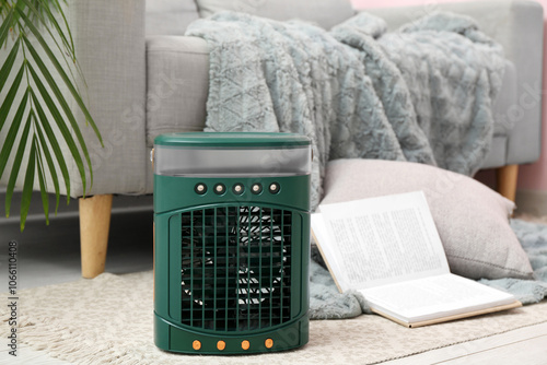 Portable table fan with boo...