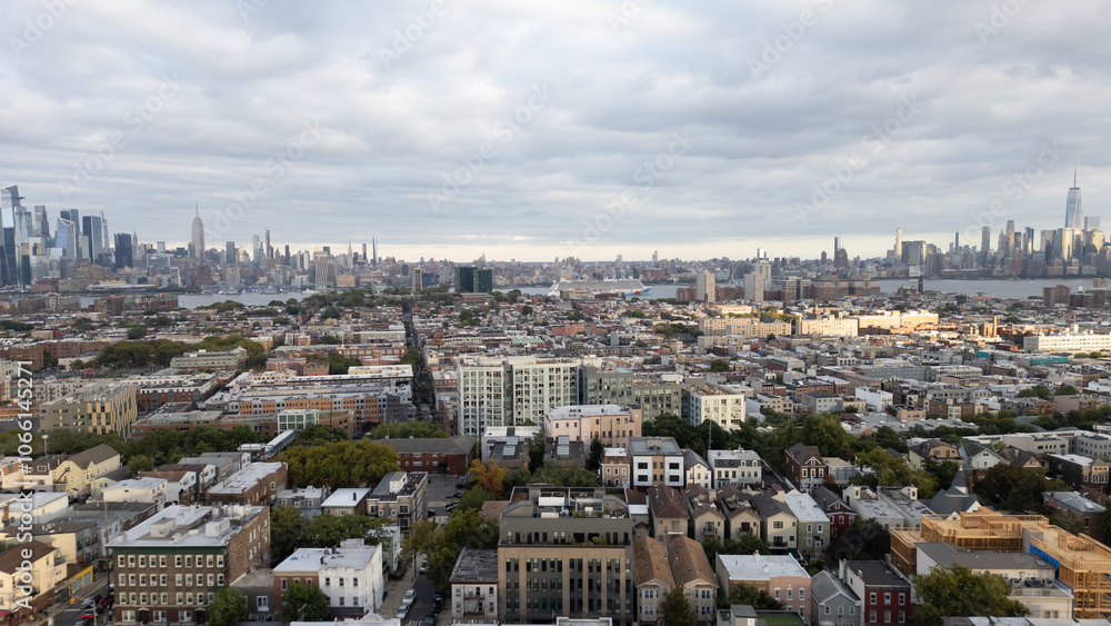 Fototapeta premium Capturing the urban charm of Jersey City Heights, this aerial view showcases the vibrant residential neighborhoods, tree-lined streets, and a sprawling cityscape. The bustling energy of this area blen