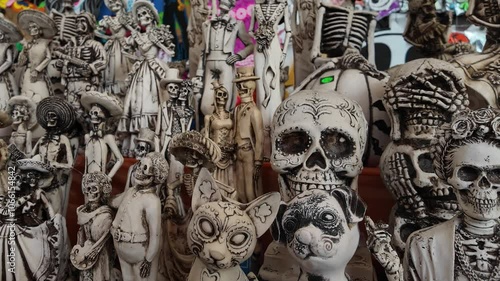 A collection of Halloween themed figurines, including a skeleton and a cat