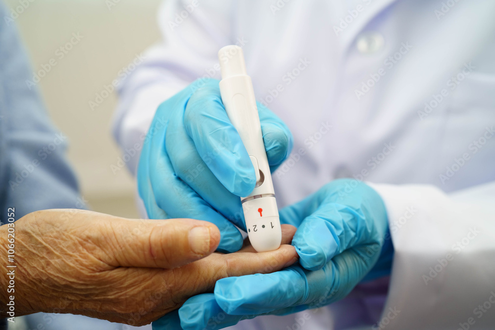 Asian doctor using digital glucose meter for check sample blood sugar level to treatment diabetes. Asian doctor using digital glucose meter for check sample blood sugar level to treatment diabetes.