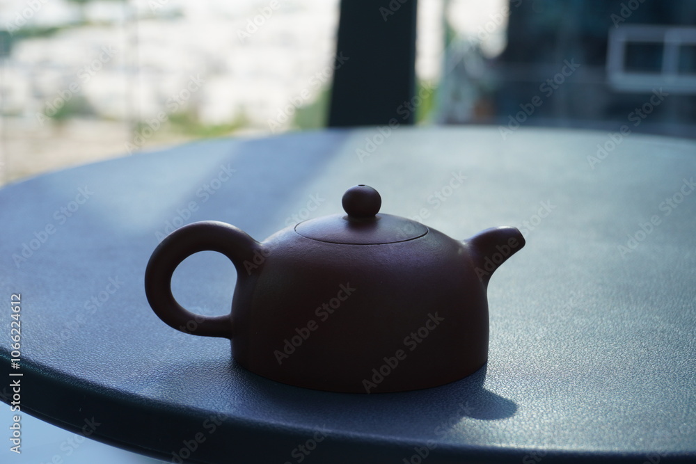Small red Chinese teapot on the table. Yixing clay teapot Small red Chinese teapot on the table. Yixing clay teapot