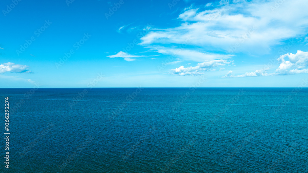 Obraz premium Nature of the beach and sea Summer with sunshine, sandy beaches, clear blue waters sparkling against the blue sky. On an island with good ecology and environment Background for summer vacation concept