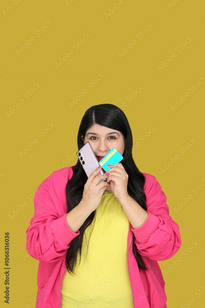 30-year-old Latina woman makes purchases on her cell phone with a credit card, very excited about the sales and discount season