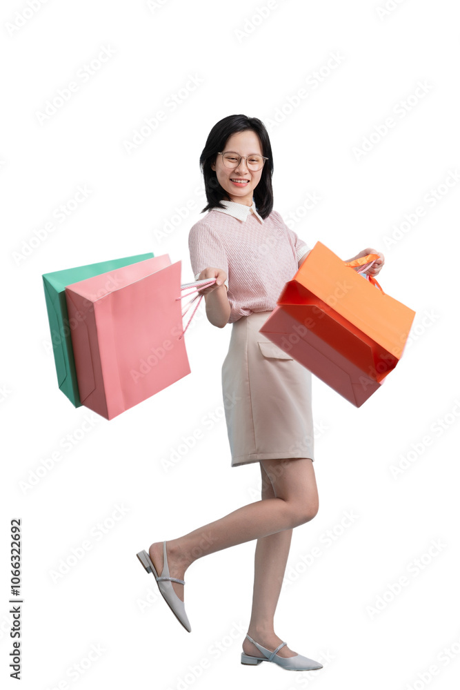 Young Asian woman holding shopping bag on blue background Young Asian woman holding shopping bag on blue background