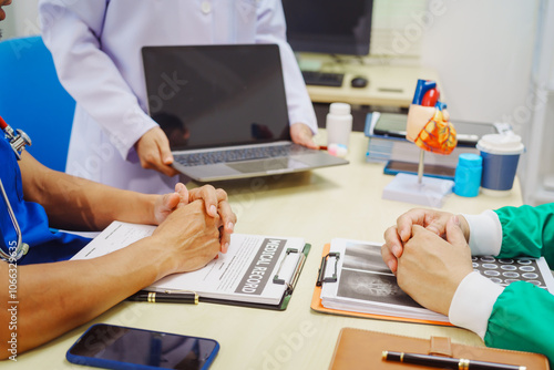 Doctors meet at a hospital desk to discuss a patient’s heart health, including conditions like coronary artery disease, arrhythmia,cardiac muscle disease,congenital issues, infectious heart diseases photo