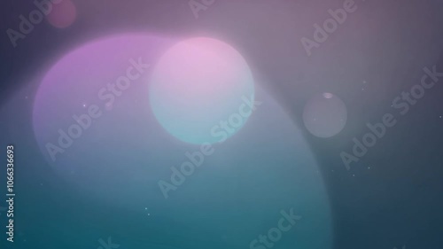 Soft, glowing orbs of various colors floating against a dark background