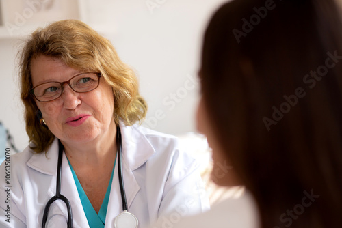 Young woman patient consultation with senior doctor about psychotherapy in modern medical office, doctor talking and discussion with patient about mental health and consoling, medical and health.