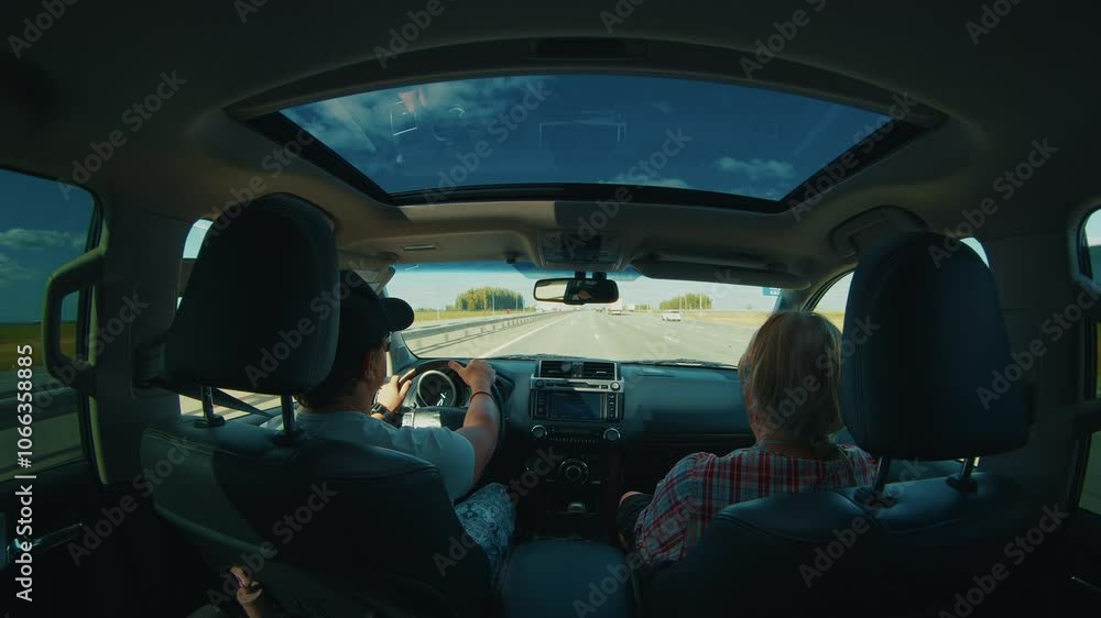Man and woman travel in the car on the highway on sunny summer day Man and woman travel in the car on the highway on sunny summer day