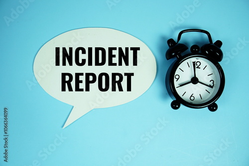 Incident Report text on speech bubble with alarm clock top view on blue background photo