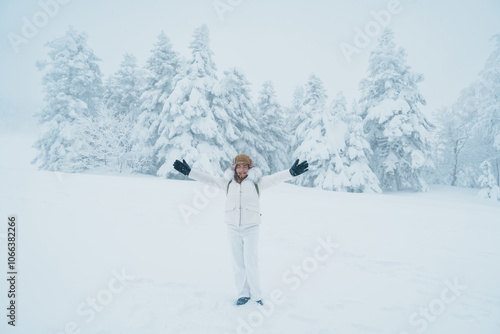 Woman tourist sightseeing Snow monster in Winter day at Mount Zao, Yamagata prefecture, Japan. Happy Traveler walking on powder snow covered in frosty weather. Travel, Adventure and Vacation