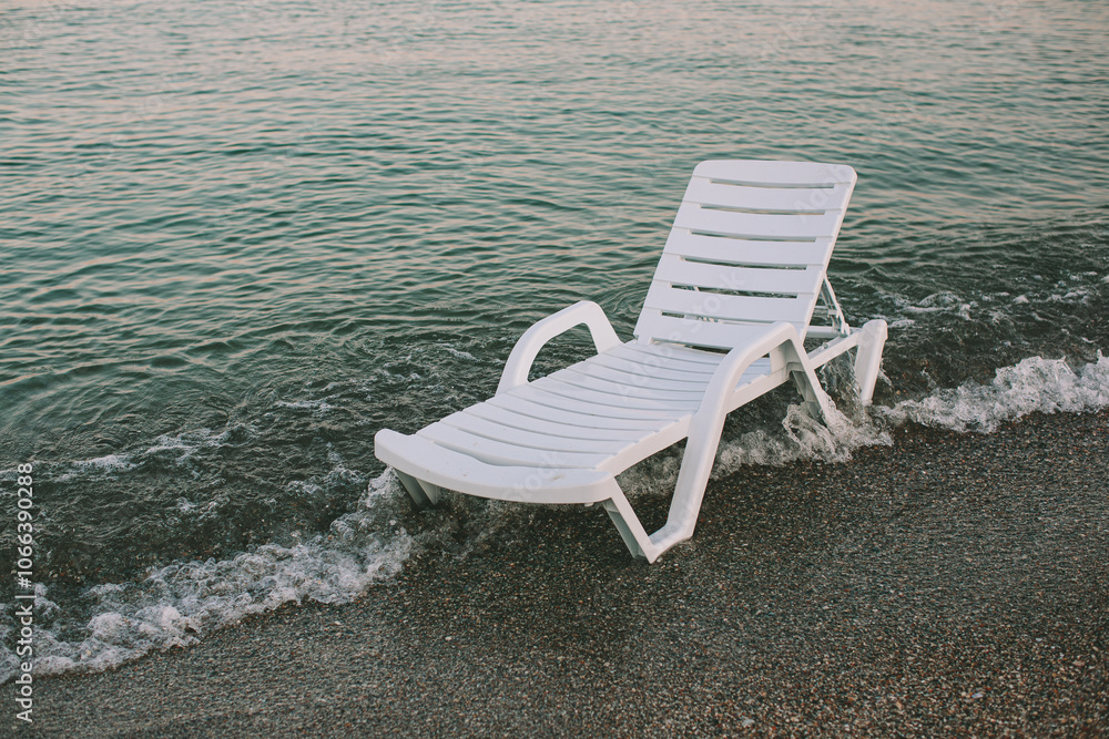 White Beach Lounger by the Edge of the Sea at Sunset White Beach Lounger by the Edge of the Sea at Sunset