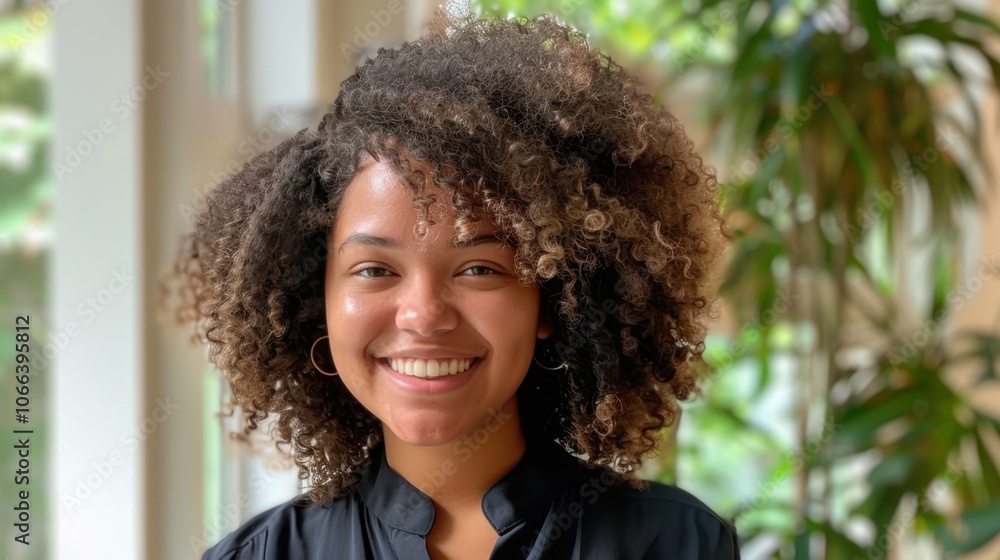 Lush Curls: Smiling with voluminous curls, this woman showcases her stunning natural texture, promoting confidence and the beauty of embracing curly hair.
Lush Curls: Smiling with voluminous curls, this woman showcases her stunning natural texture, promoting confidence and the beauty of embracing curly hair.