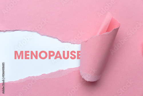 Pink Torn Paper Revealing the Word Menopause