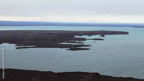 Above view of the water and islands of Embalse Ezequiel Ramos Mexía in argentina, grey sky, pan shot with copy space photo