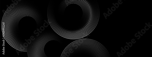 Abstract background with circular line patterns on black background.