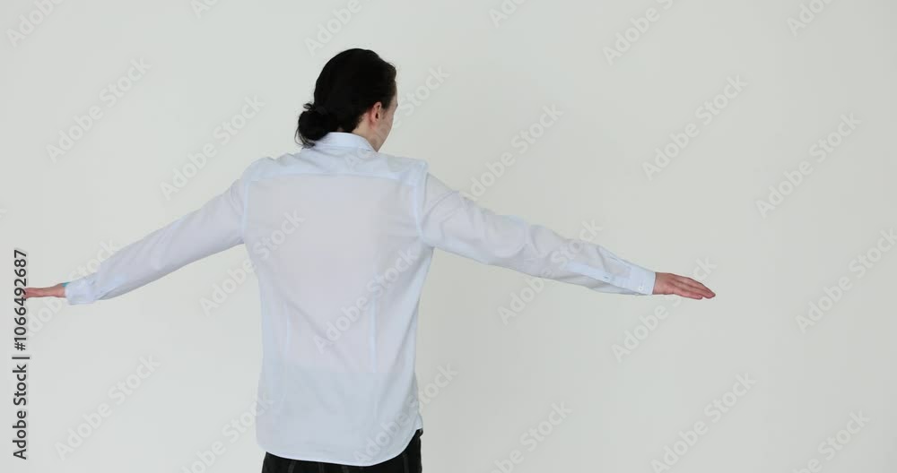Young man spins on white background. Greet new day feel alive and active Young man spins on white background. Greet new day feel alive and active