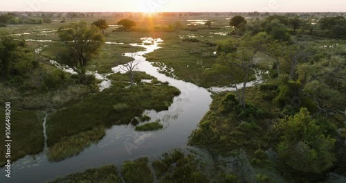 Aerial zoom in view of  the winding rivers in the Okavango Delta at sunset