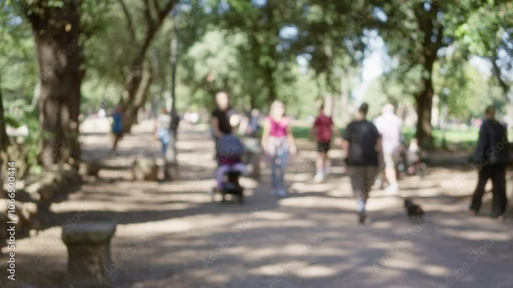 People walk through blurred tree-lined path in villa borghese gardens with bokeh effect on sunny day in rome, showcasing outdoor leisure and natural scenery. People walk through blurred tree-lined path in villa borghese gardens with bokeh effect on sunny day in rome, showcasing outdoor leisure and natural scenery.