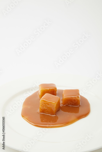 caramel candies and caramel sauce isolated on a white background