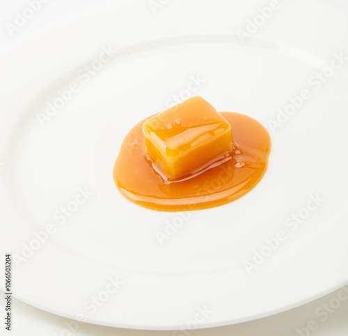 caramel candies and caramel sauce isolated on a white background