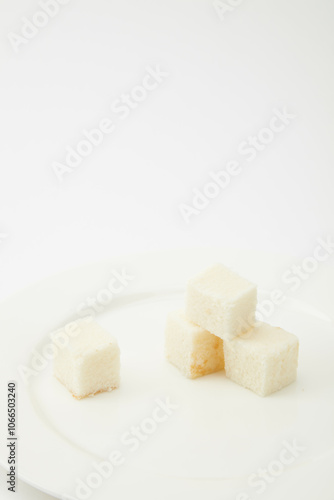 Block of creamy white cheese isolated on a clean white background, Flying cubes of fresh white cheese, captured in mid-air against a white backdrop