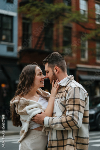 A romantic couple is embracing and smiling in a closeup moment of love