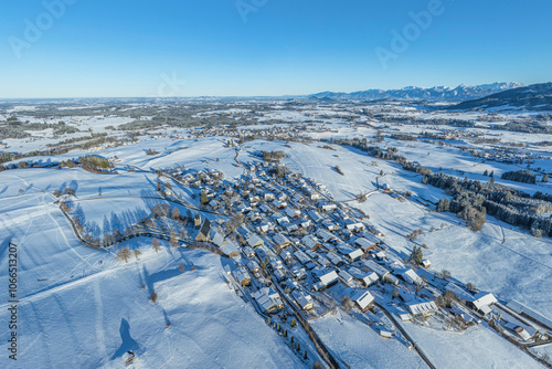 Das verschneite Allgäu bei Mittelberg an einem romantischen Winterabend von oben photo