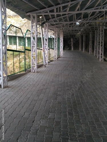 A walkway on mountains covered with sheds for protection from rain and sun rays on the way to Mata Vaishno Devi bhawan photo