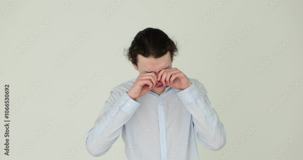Young man crying in despair on a white background Young man crying in despair on a white background