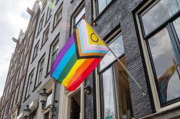 Progress Pride flag displayed on the exterior of a historic building