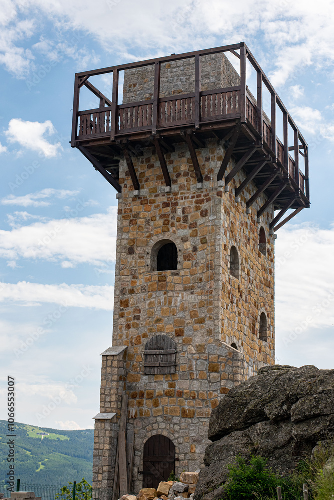 Wysoki Kamien peak at 1058m in the Jizera Mountains, crowned by a tower, offers sweeping mountain views. Wysoki Kamien peak at 1058m in the Jizera Mountains, crowned by a tower, offers sweeping mountain views.
