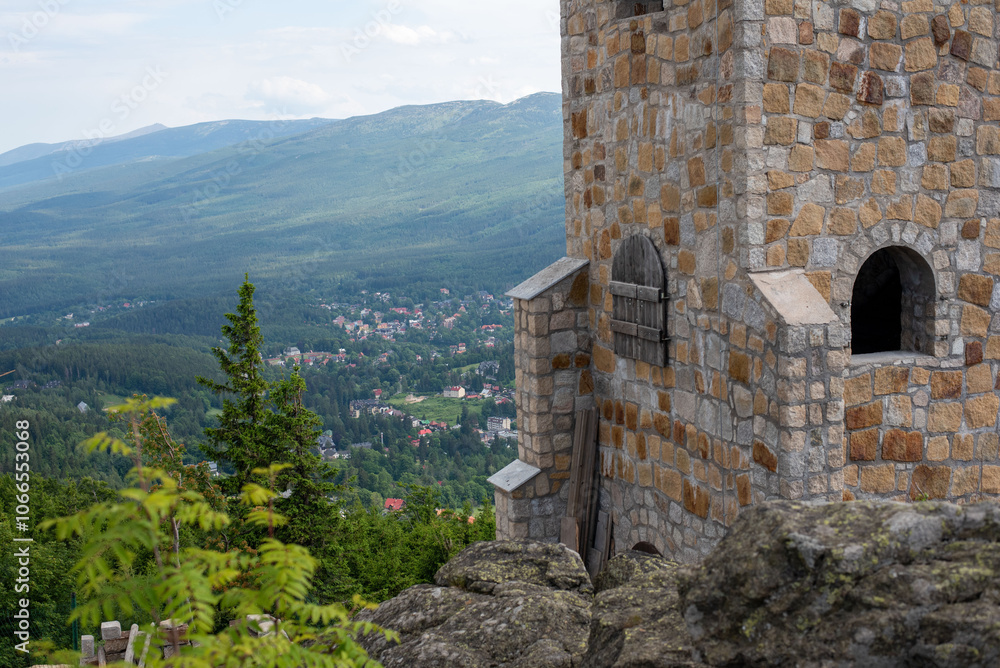Wysoki Kamien peak at 1058m in the Jizera Mountains, crowned by a tower, offers sweeping mountain views. Wysoki Kamien peak at 1058m in the Jizera Mountains, crowned by a tower, offers sweeping mountain views.