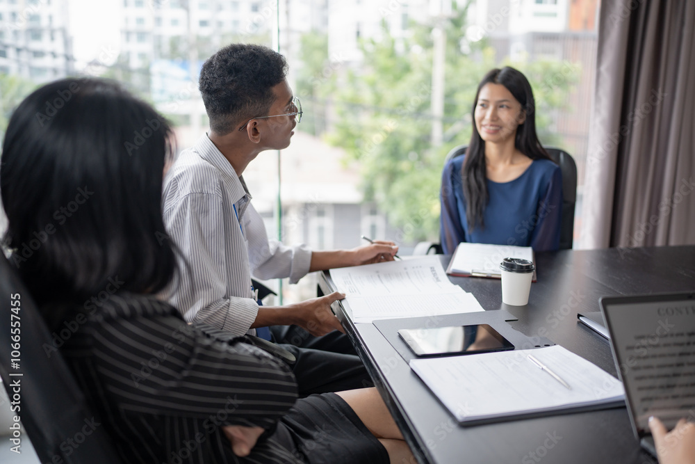 Examiner reading a resume during job interview at office Business and human resources concept. Examiner reading a resume during job interview at office Business and human resources concept.