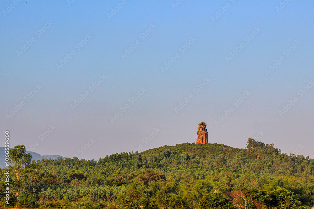 Phu Loc Tower - an ancient Champa tower - glowing red in the sunset, built on top of a low hill in An Nhon, Binh Dinh, Vietnam, dating back nearly 1,000 years. National historical relic of Vietnam Phu Loc Tower - an ancient Champa tower - glowing red in the sunset, built on top of a low hill in An Nhon, Binh Dinh, Vietnam, dating back nearly 1,000 years. National historical relic of Vietnam
