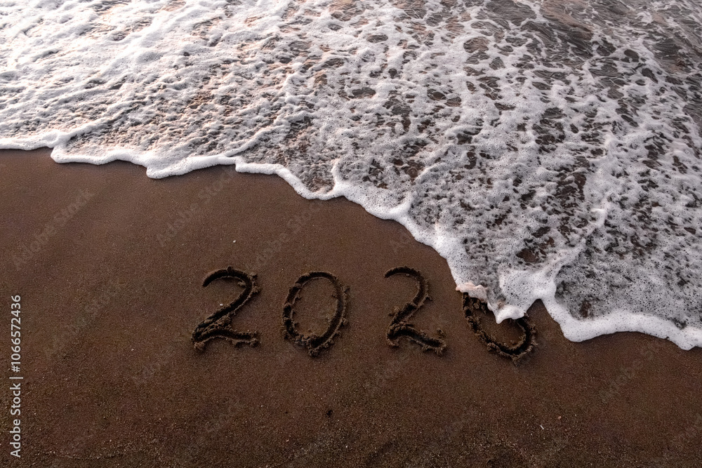 Fototapeta premium Christmas inscription 2005 on the summer beach