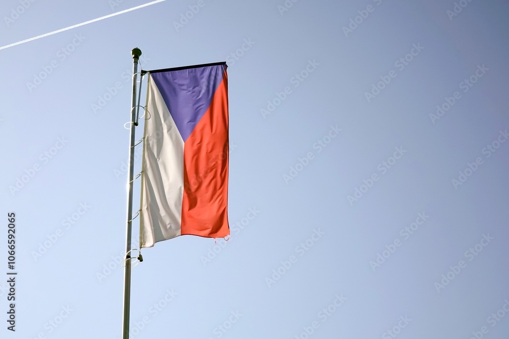 Czech national flag with blue sky and backlight, copy space