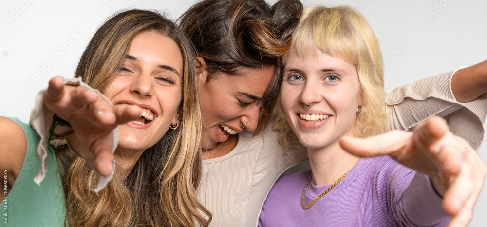Playful diverse friends reaching camera joyful expression authentic young dynamic laughing closeup genuine happy Playful diverse friends reaching camera joyful expression authentic young dynamic laughing closeup genuine happy